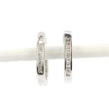 A pair of 18ct white gold hoop earrings set with princess cut diamonds, L. 1.5cm.