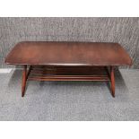 A matching Ercol oak coffee table with ladder style shelf, 103 x 46 x 36cm.