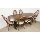 An Ercol oak dining table with six windsor quaker matching Ercol chairs, table 180 x 80cm.