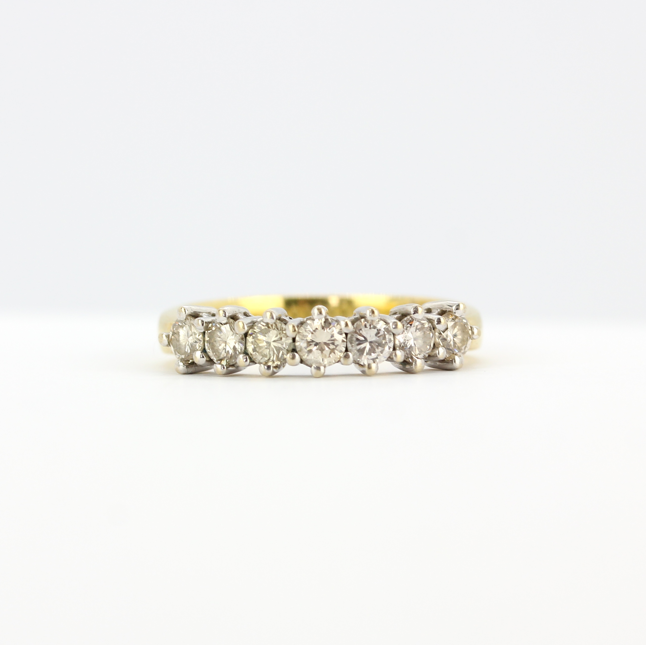 An 18ct yellow gold ring set with brilliant cut diamonds, (N), approx. 0.70ct total.