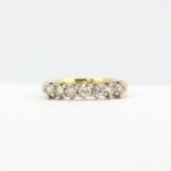 An 18ct yellow gold ring set with brilliant cut diamonds, (N), approx. 0.70ct total.