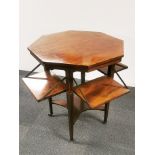 An Edwardian mahogany veneered and inlaid octagonal two-tier table with four interesting fold out