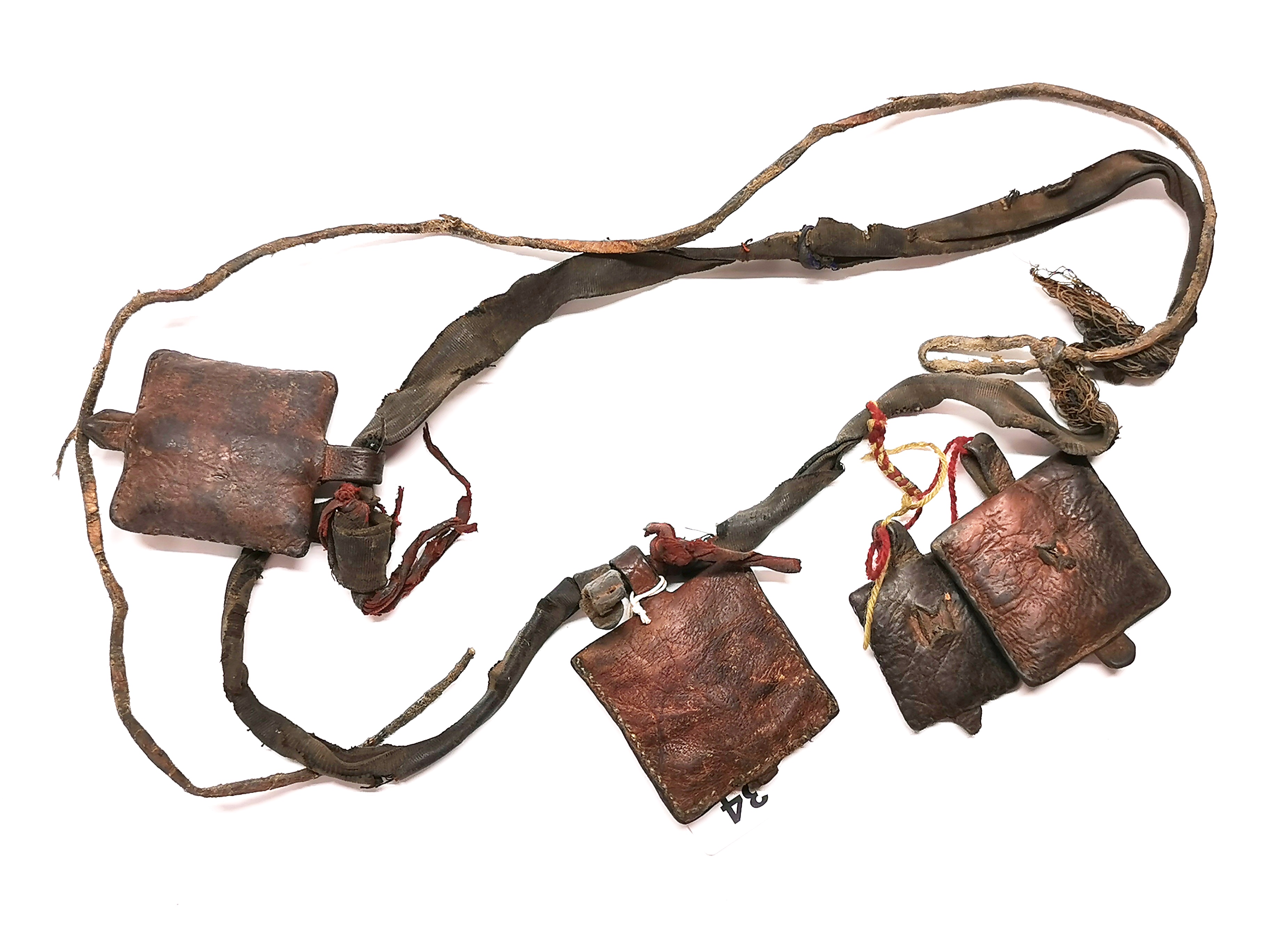A Tibetan Nomad's leather sash with pouches containing prayers originally from Gyantse, Tibet. Prov.