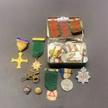 A quantity of mixed medals and badges.