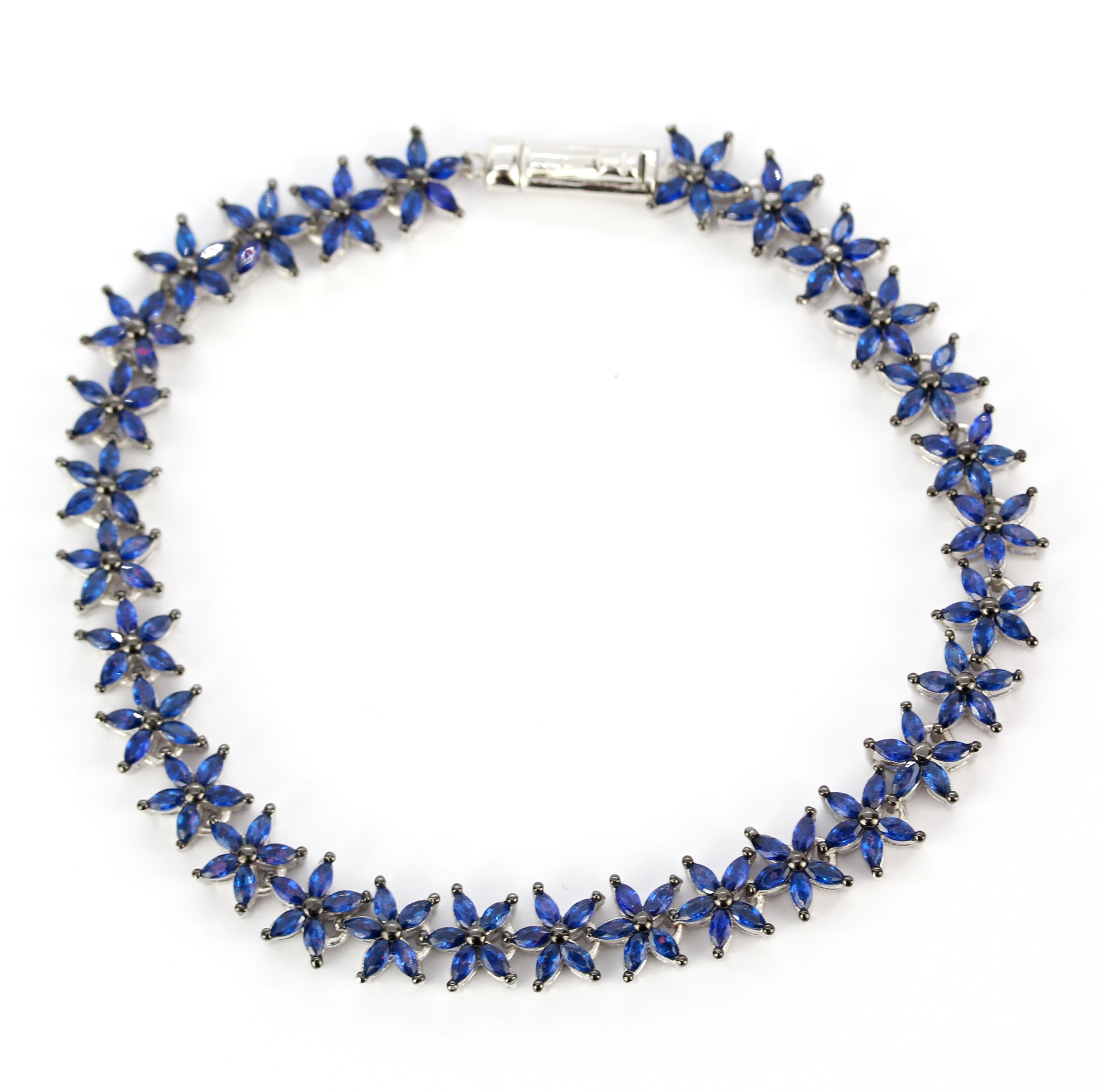 A 925 silver flower style tennis bracelet set with marquise cut sapphires, L. 19cm.