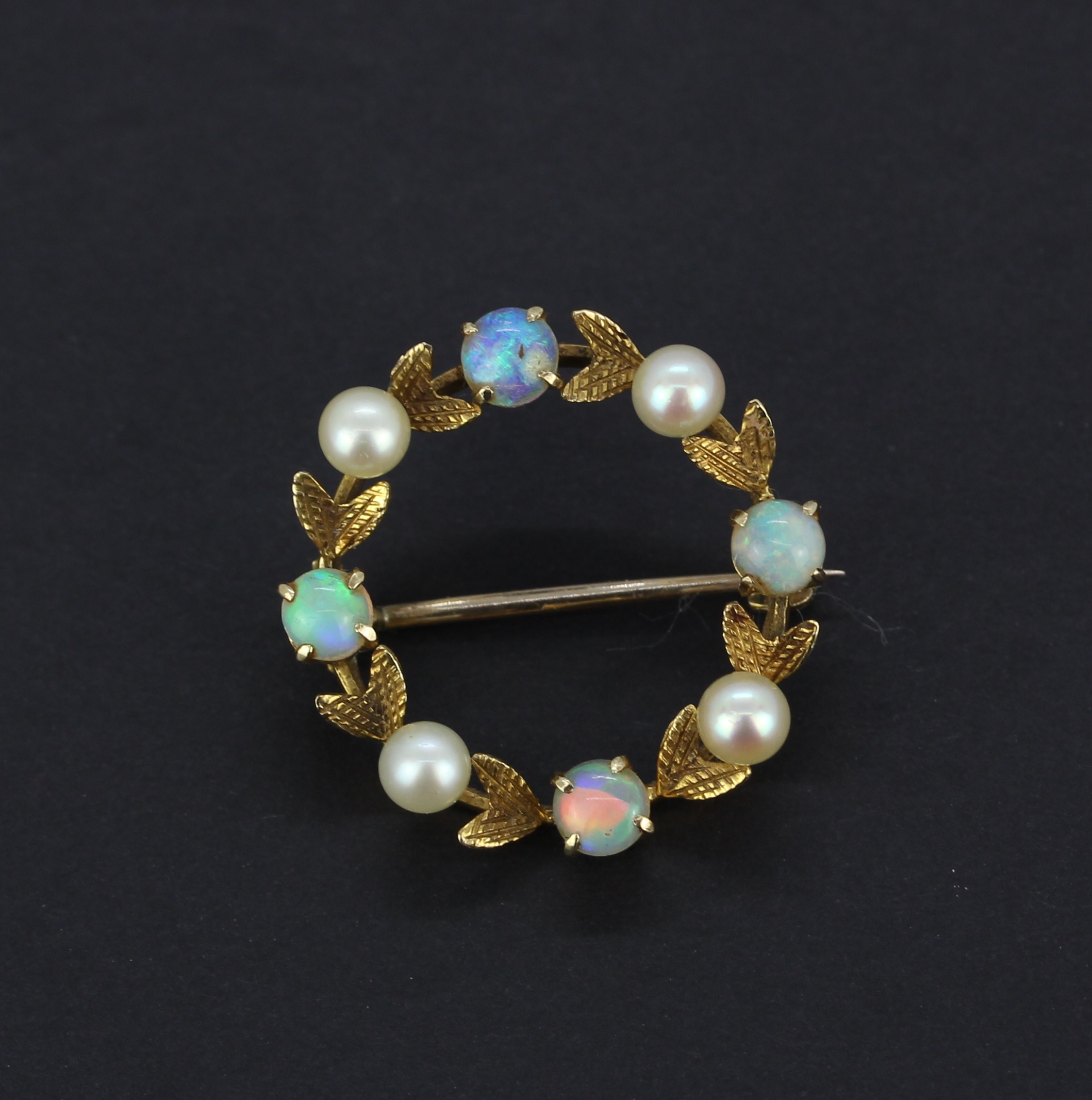 A 9ct yellow gold brooch set with round cabochon cut opals and pearls, dia. 2.5cm.