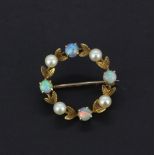 A 9ct yellow gold brooch set with round cabochon cut opals and pearls, dia. 2.5cm.