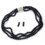 A pretty three row necklace of blue black 6mm cultured pearls, shortest row L. 38cm, together with a