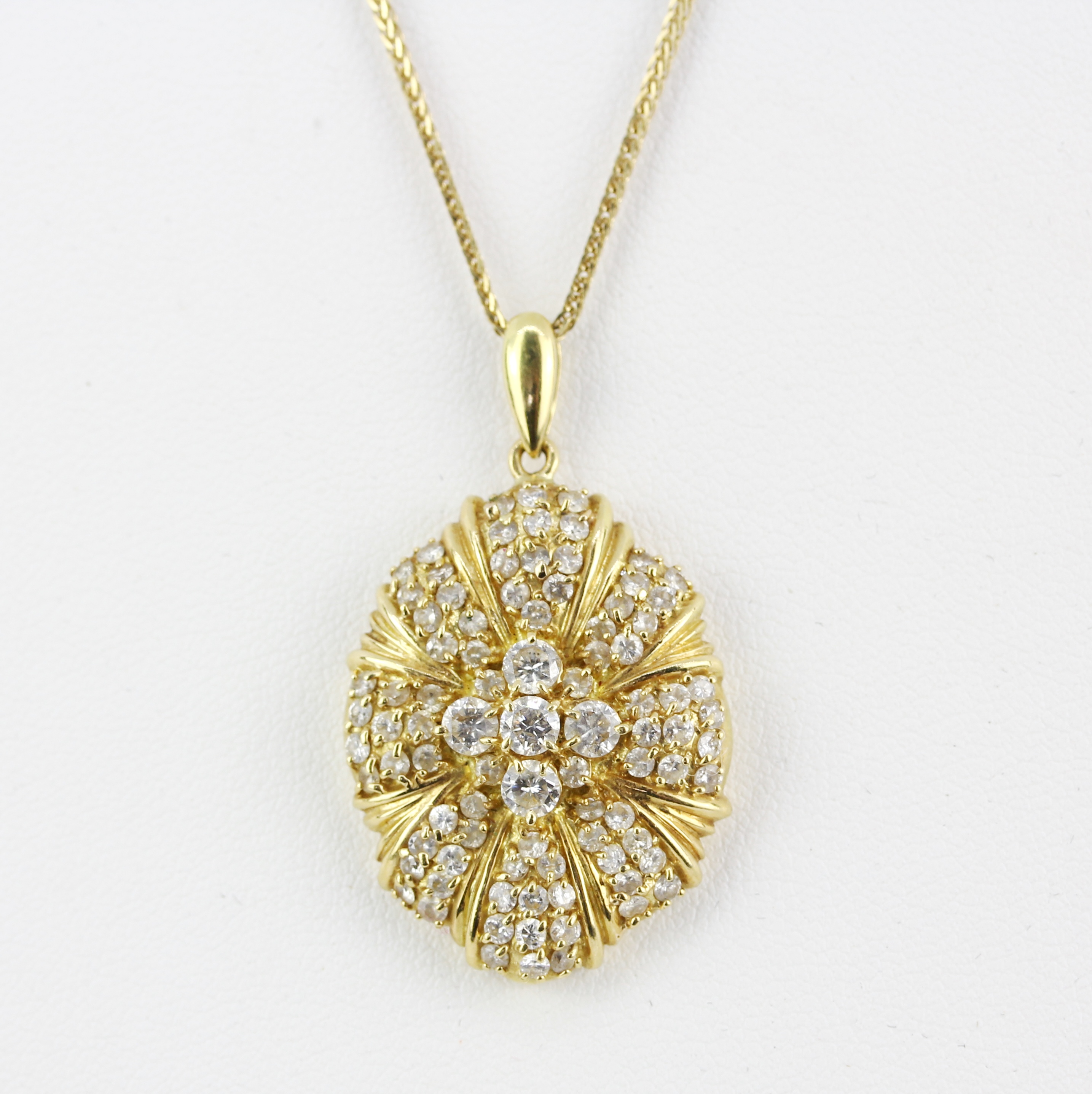 A large hallmarked 18ct yellow gold pendant set with brilliant cut diamonds, L. 3cm, on a hallmarked