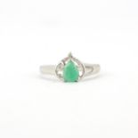 A hallmarked 9ct white gold ring set with jade? and a diamond, (N).