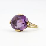 A yellow metal (tested minimum 9ct gold), set with a large oval cut amethyst, (K.5).