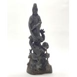 A Chinese cast bronze figure of the Goddess Guanyin standing on a dragon, H. 36cm.