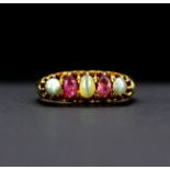 A heavy yellow metal (tested 18ct gold) ring set with cabochon oval cut cat's eye, chrysoberyl and