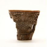 A Chinese carved horn libation cup, H. 13cm.