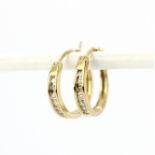 A pair of hallmarked 9ct yellow gold diamond set hoop earrings, dia. 1.5cm.
