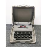 A vintage metal cased Olympia portable typewriter.