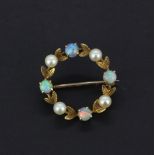 A 9ct yellow gold brooch set with round cabochon opals and pearls, dia. 2.5cm.