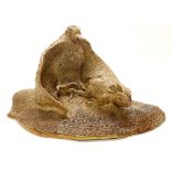 An unusual, impressive clay sculpture of an eagle catching a rat, W. 41cm, H. 20cm.