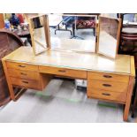 A mid century Uniflex figured walnut dressing table with three way mirror, 161 x 50 x 120cm.