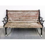 An old cast iron and wood garden bench, W. 130cm.