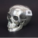 A silver plated bronze / brass skull with hinged jaw, H. 9.5cm, W. 12cm.