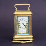 A miniature gilt brass carriage clock with Sevres style porcelain panels and face, appears to be