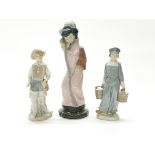 Three Lladro porcelain figures, tallest H. 29cm.