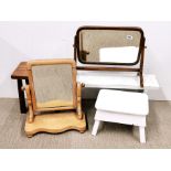 A group of three wooden stools and two dressing table mirrors.
