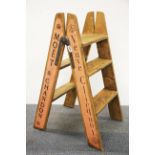 A pair of folding pine advertising steps, H. 81cm.