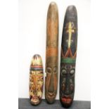 Three carved wooden tribal masks, longest L. 98cm.