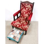 An upholstered Edwardian armchair and footstool.