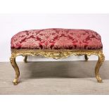 A large upholstered gilt carved wooden Victorian stool, W. 106cm.