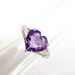 A 925 silver adjustable ring set with a heart cut amethyst and white stones.