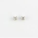 A pair of 9ct yellow and white gold solitaire stud earrings each set with a brilliant cut diamond,