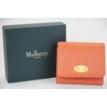 A boxed Mulberry plaque small French purse in coral rose.
