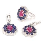 A suite of matching 925 silver pair of earrings and ring, set with oval cut rubies surrounded by