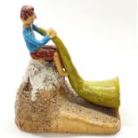 An interesting studio pottery figure of a boy playing a mountain horn, H. 23cm.