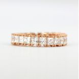 A rose gold on 925 silver full eternity ring set with princess cut cubic zirconias, (M).