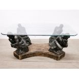 A 1970's composition and glass figural coffee table, 106 x 61 x 48cm.