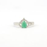 A hallmarked 9ct white gold ring set with jade and a diamond, (N).