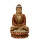 A Chinese painted carved wooden figure of a seated Buddha, H. 37cm.