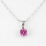 A 9ct white gold pendant set with a fancy cut pink sapphire, L. 0.7cm, on a 9ct white gold chain, L.