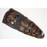 An African carved hardwood tribal mask, H. 56cm.