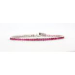 A 925 silver tennis bracelet set with princess cut pink topaz, L. 20.5cm.