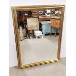 A large gilt framed bevelled glass mirror, 89 x 114cm.