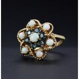 A large hallmarked (worn hallmark) 9ct yellow gold ring set with round cabochon opals and round