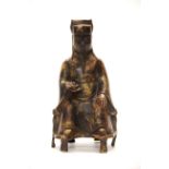 A Chinese painted and gilt bronze figure of a seated Emperor (Lucky God) H. 23cm.