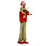 A 1960's clockwork tin figure of a clown playing a violin, H. 23cm.