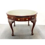 A re-polished early 19th century circular mahogany library table with replacement leather top,