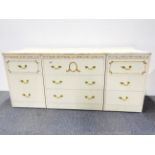 A 1970's chest and pair of bedside cabinets, chest W. 91cm, H. 60cm.